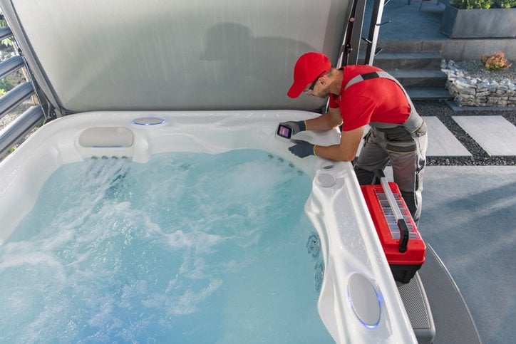 hot tub service technician working on a hot tub