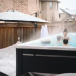 family playing in a outdoor swim spa in winter